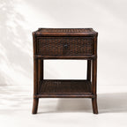 Plantation 1 Drawer Bedside table in dark wood with woven rattan panels and a single drawer.