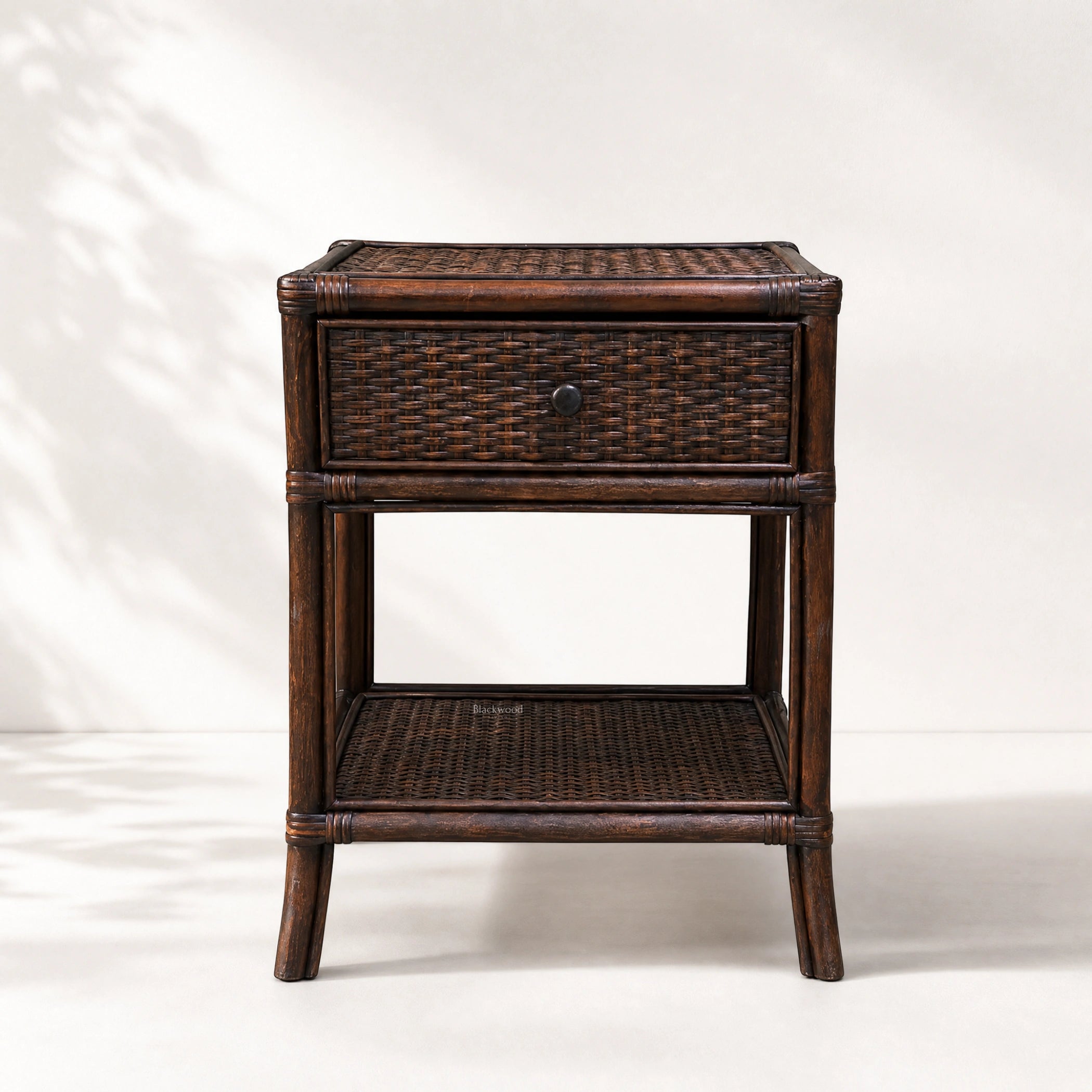 Plantation 1 Drawer Bedside table in dark wood with woven rattan panels and a single drawer.