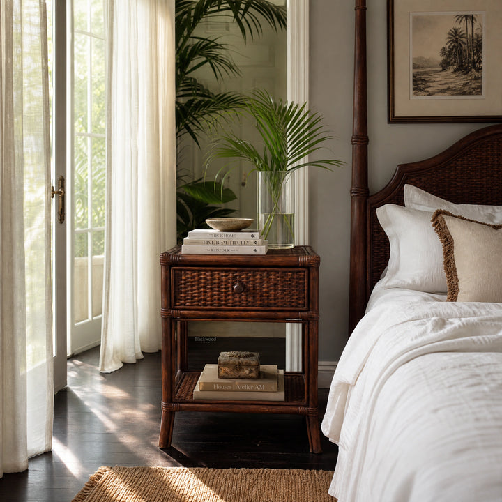 Plantation 1 Drawer Bedside table in handcrafted rattan with woven detailing and storage beside a bed.