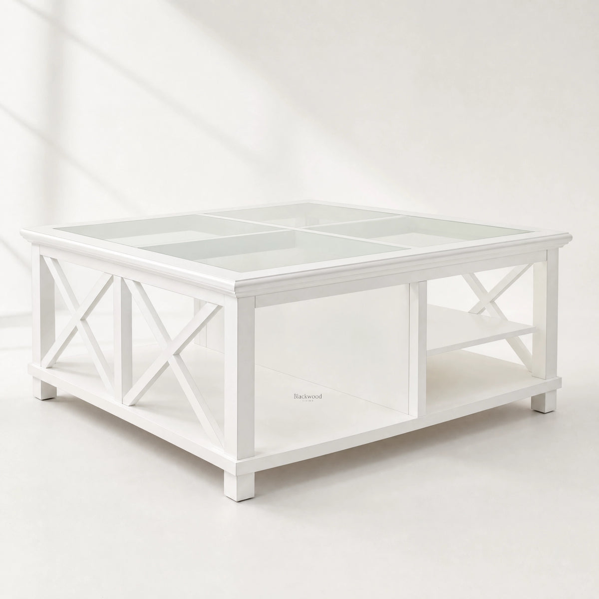 Harbour Coffee Table, coastal-inspired white timber with glass top and crisscross legs.