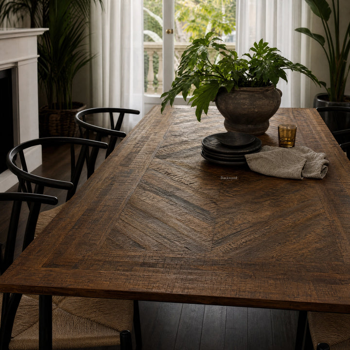 Havana Dining Table in walnut-finished reclaimed mango wood with rich grain patterns, centerpiece plant in rustic pot