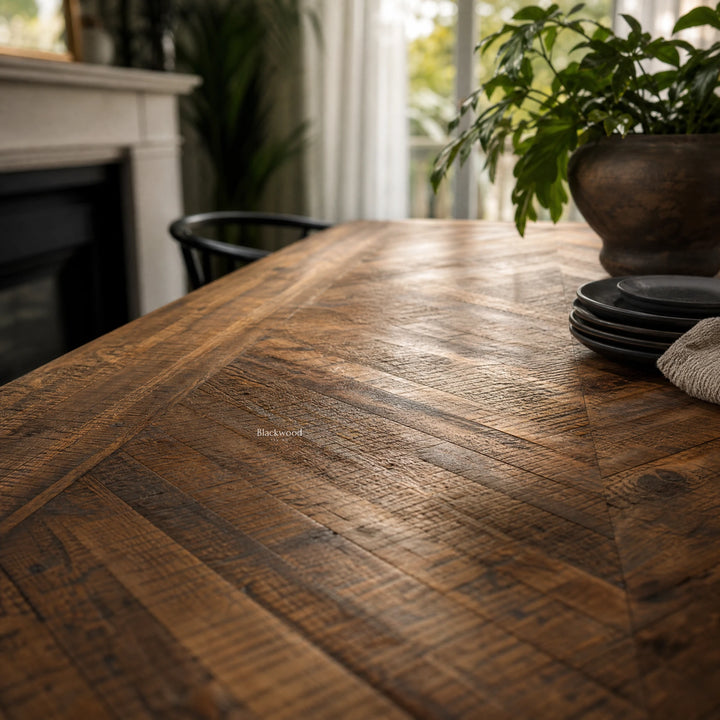 Havana Dining Table in walnut-finished reclaimed mango wood with rich grain; plant and plates on the table.
