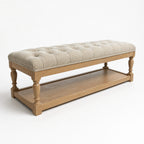 Oakfield Bench: tufted beige upholstery on a sculpted oak frame with sturdy legs.