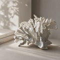 White coral ornament on a shelf; faux coral sculpture in polyresin for coastal decor.