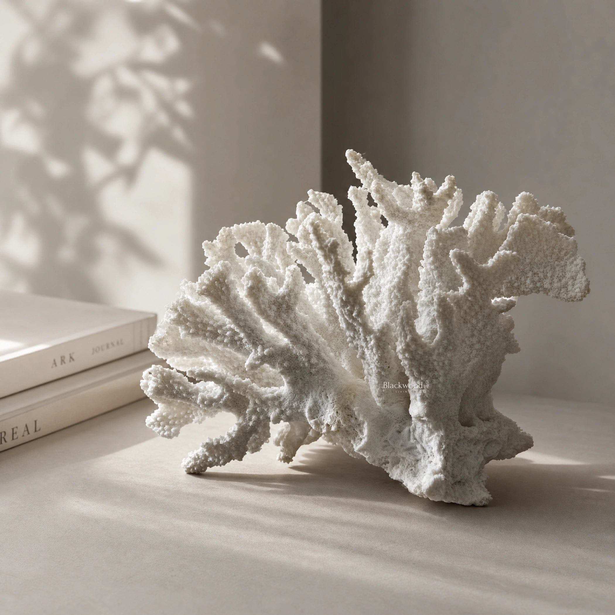 White coral ornament on a shelf; faux coral sculpture in polyresin for coastal decor.