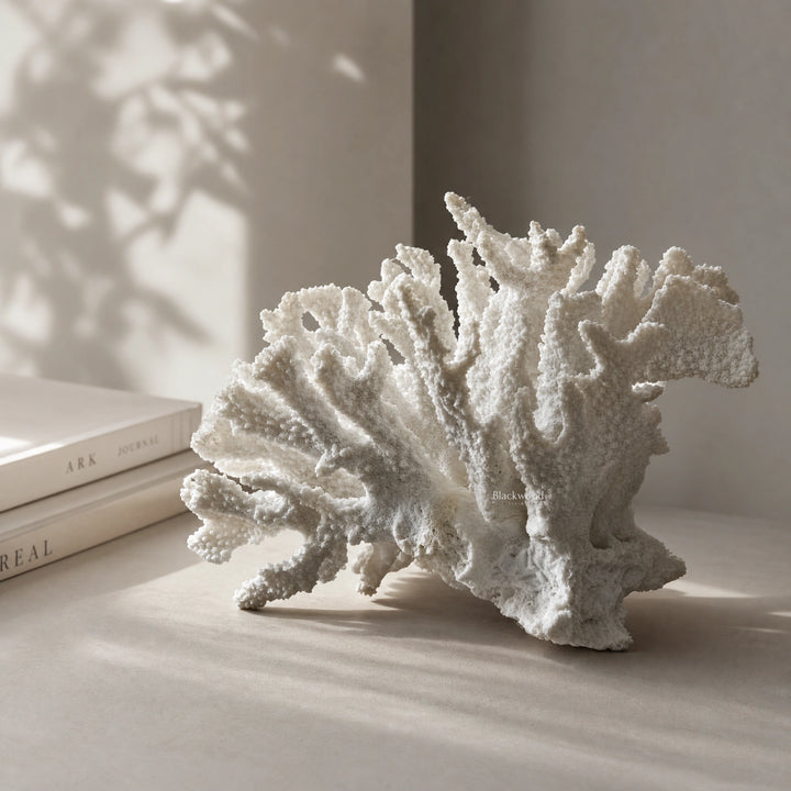 White coral ornament on a shelf; faux coral sculpture in polyresin for coastal decor.