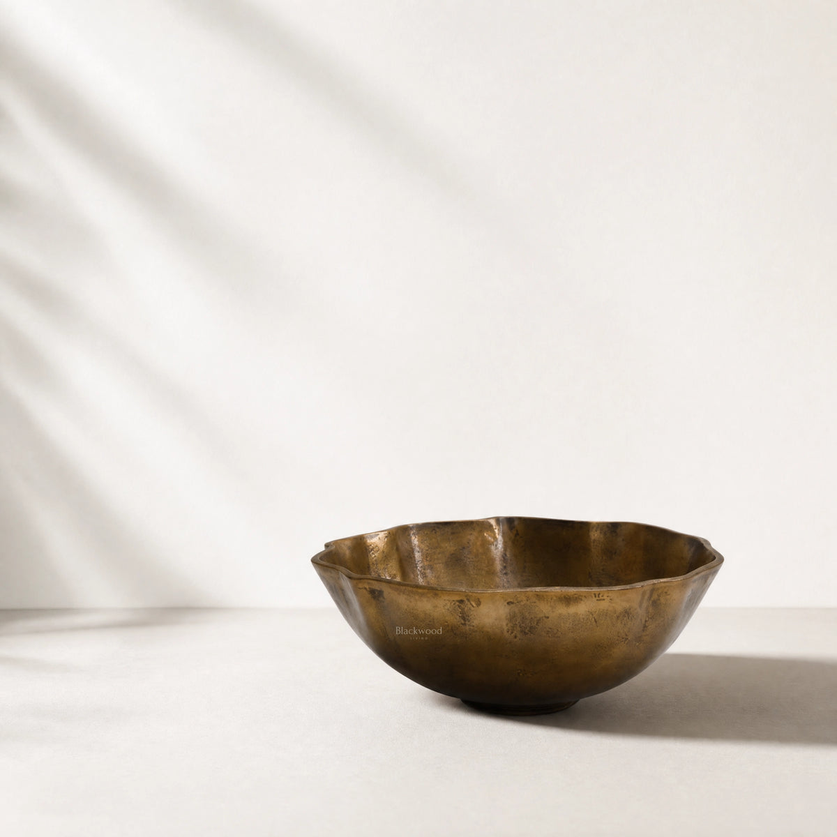 Ankara Gilded Poppy Bowl, handcrafted aluminium with brass finish, undulating form and aged patina.