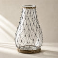 Tide Wire Glass Vase featuring clear glass with hand-wrapped wire mesh and natural wicker base.