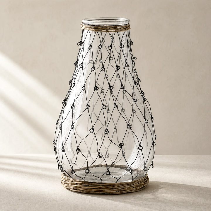 Tide Wire Glass Vase featuring clear glass with hand-wrapped wire mesh and natural wicker base.