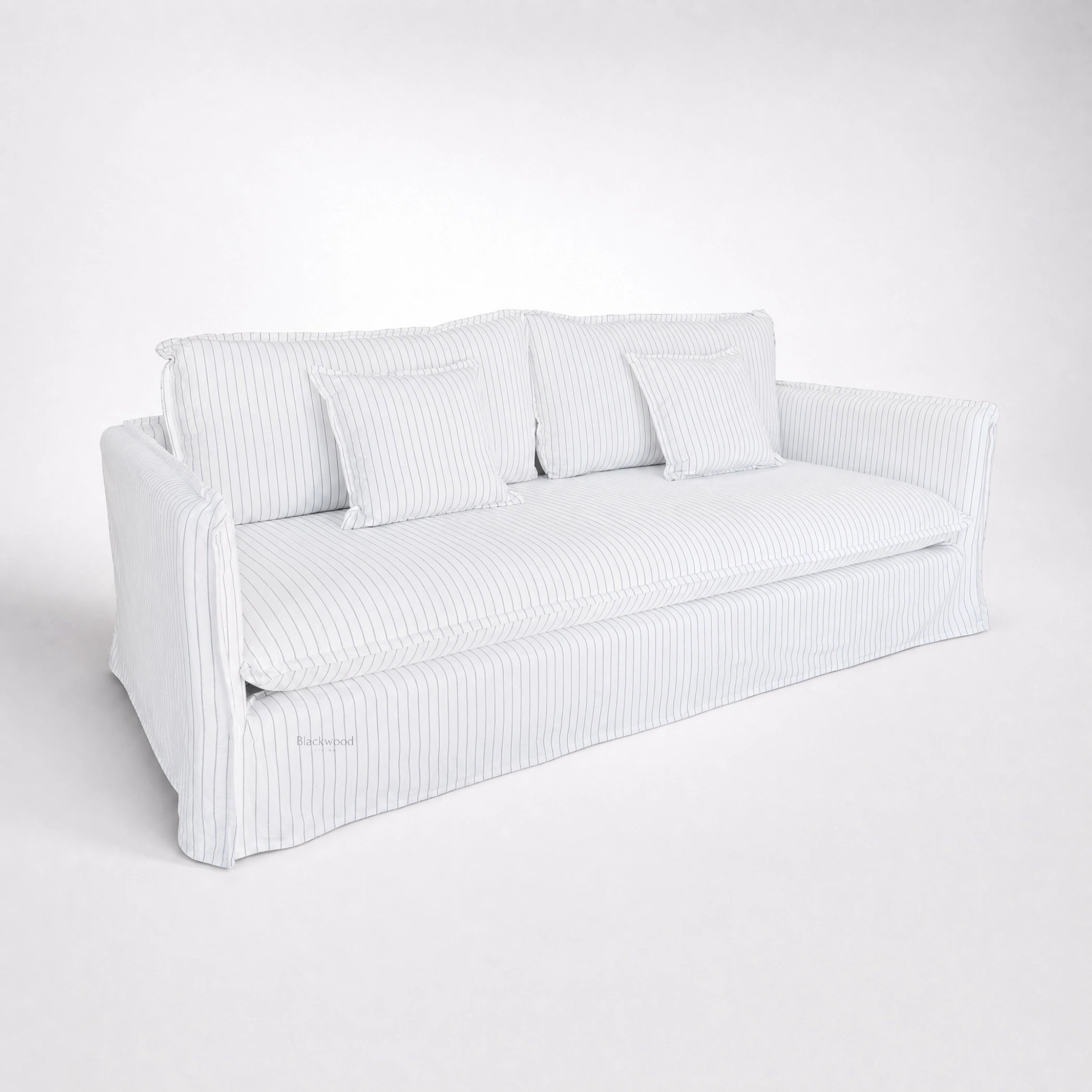 Nantucket Slipcover 3-seat sofa in light linen-cotton with grey pinstripes and matching pillows.