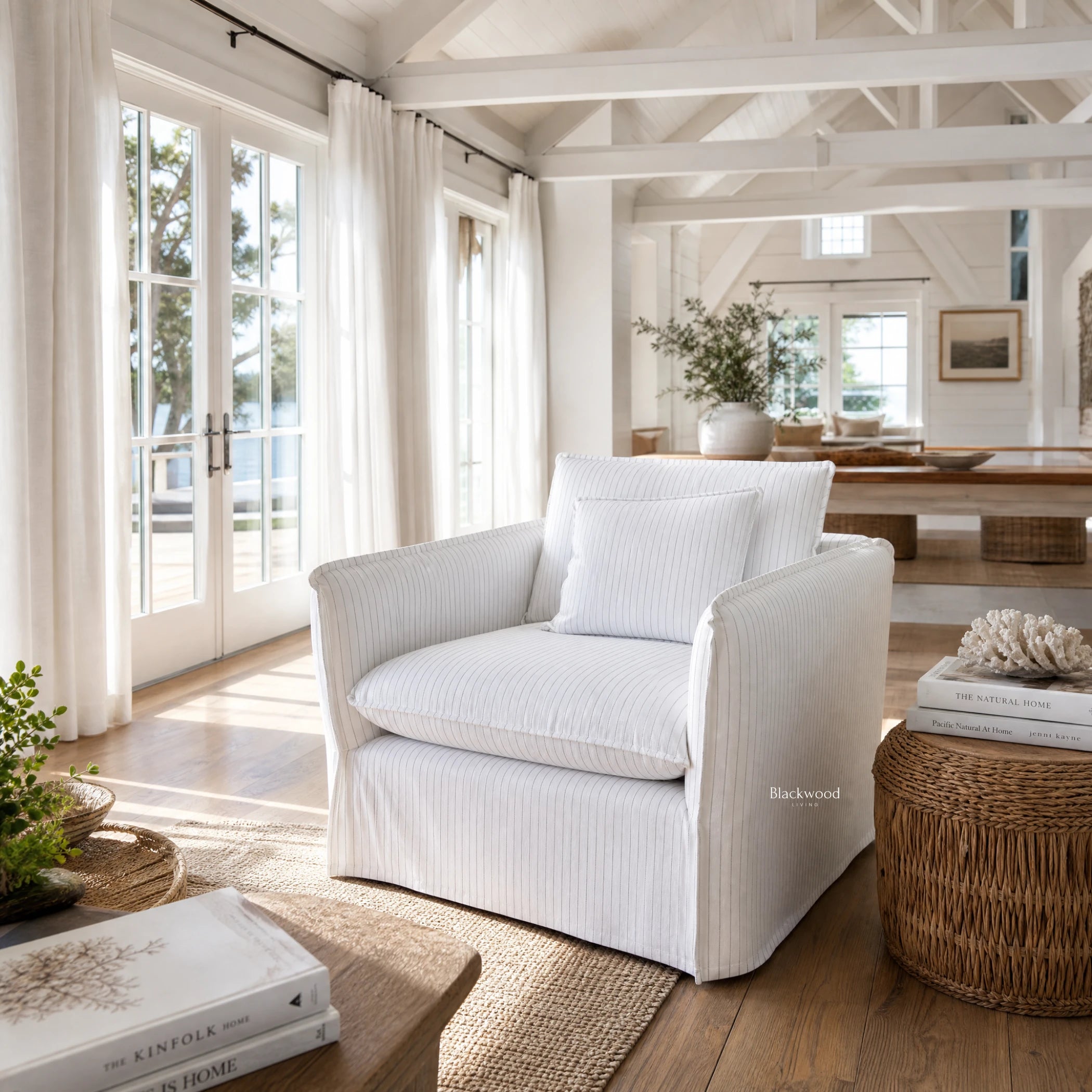 Nantucket Slipcover Armchair in light linen-cotton with subtle grey pinstripes in a bright Hamptons-style living room.