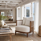 Seabrooke Chair with solid oak frame, handwoven rattan panels, and linen upholstery in a bright coastal living space.
