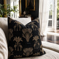 Palm Cushion Cover 55cm with black fabric and gold palm motifs on a light sofa, tropical vintage-inspired decor.