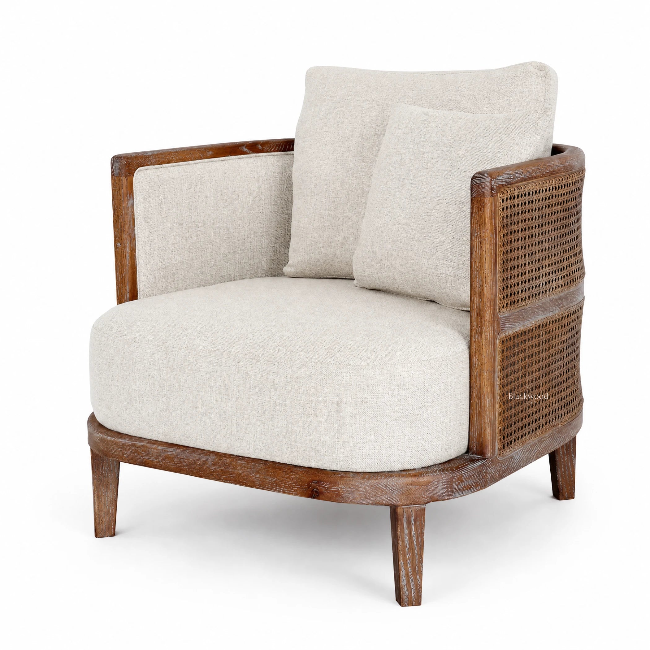 Seabrooke Chair with solid oak frame, handwoven natural rattan panels, and linen cushions.