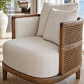Seabrooke Chair with solid oak frame, handwoven rattan panels, and soft 100% linen upholstery.