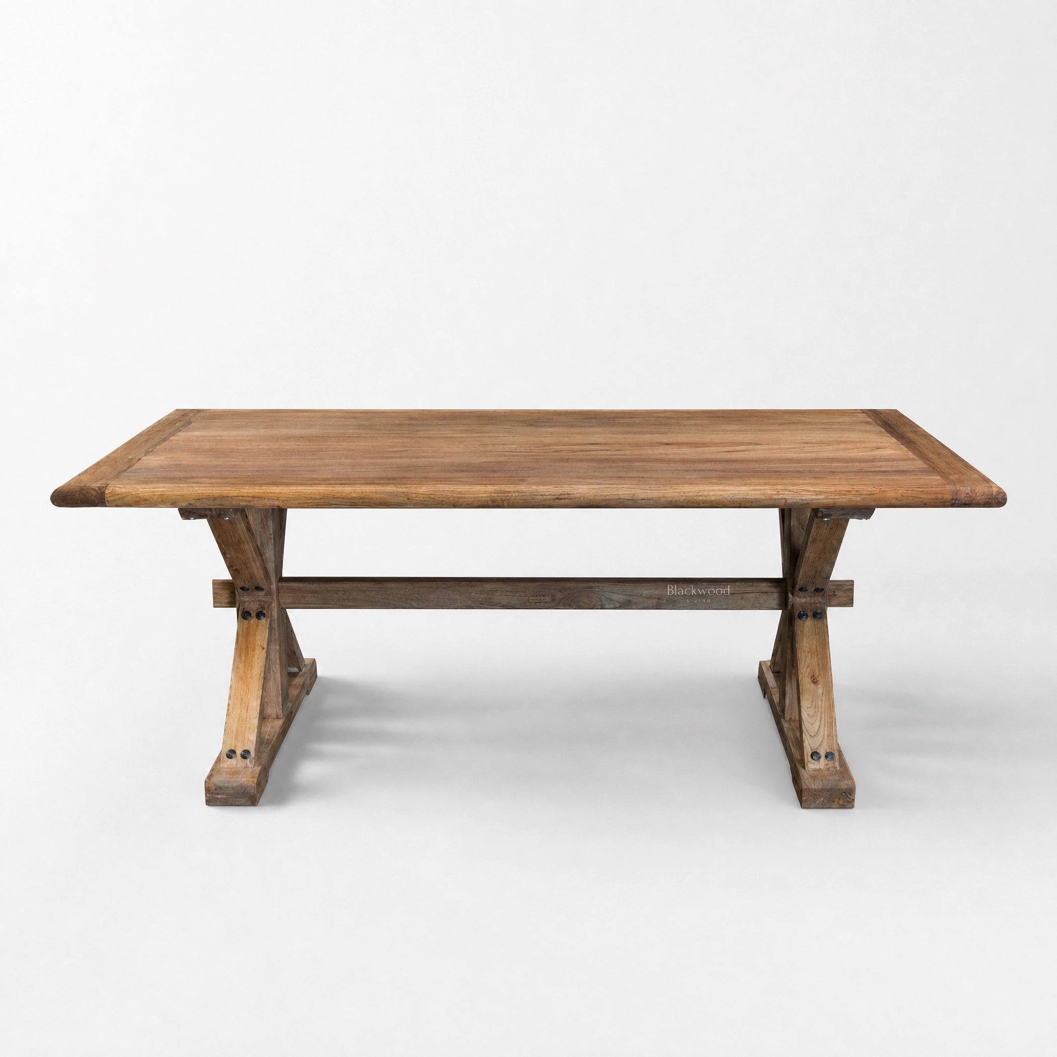 Foundry Dining Table in recycled elm with a thick top and sturdy trestle legs for family gatherings.