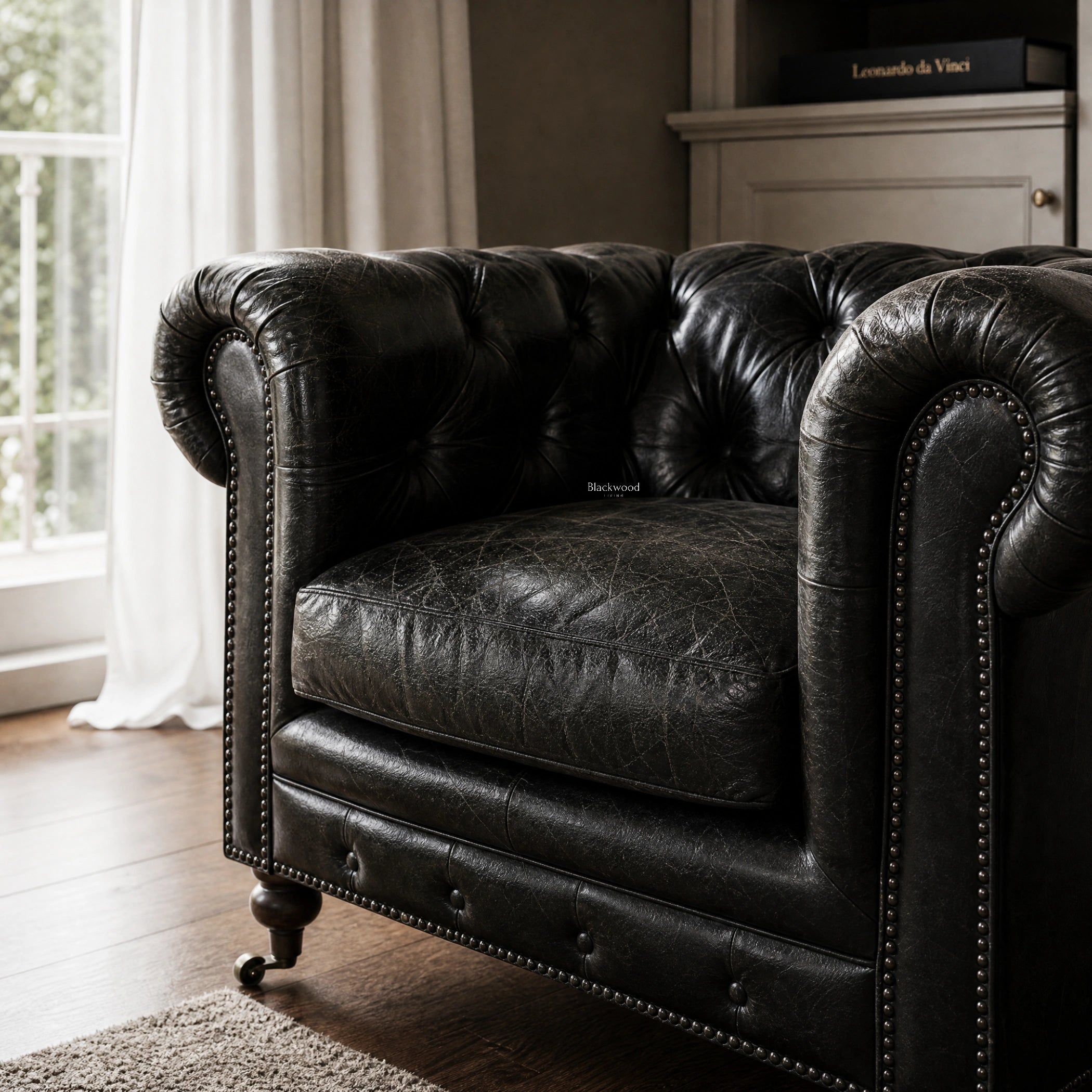 Ashcroft Armchair - Estate Black: Chesterfield leather, top-grain South American, with tufting and nailhead trim.