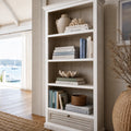 Whitehaven Bookcase in antique white mango wood with layered textures and coastal, traditional charm.