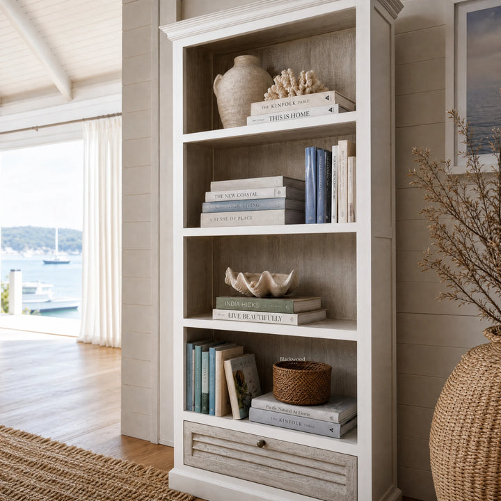 Whitehaven Bookcase in antique white mango wood with layered textures and coastal, traditional charm.