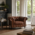 Ashcroft Armchair - Vintage Tobacco leather, deep button tufted Chesterfield in a cozy living room.
