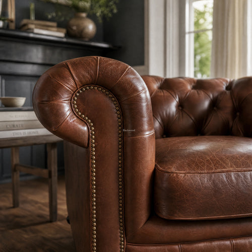 Ashcroft Armchair in Vintage Tobacco leather with deep button tufting in Chesterfield style and nailhead trim.