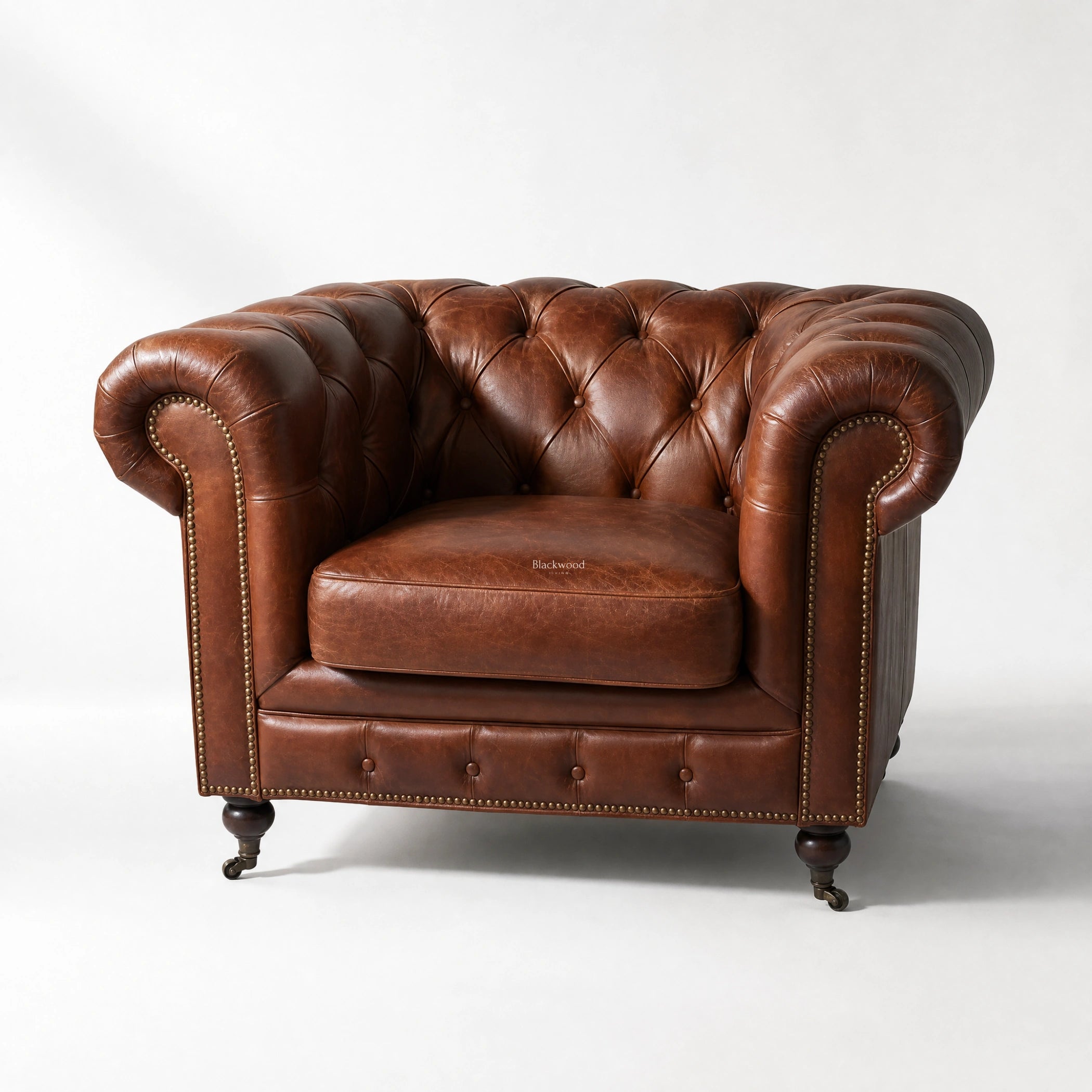 Ashcroft Armchair in Vintage Tobacco leather with deep button tufting, Chesterfield style, brass nailhead trim.