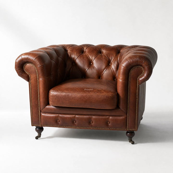 Ashcroft Armchair in Vintage Tobacco leather with deep button tufting, Chesterfield style, brass nailhead trim.