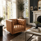 Wellington Leather Club Chair with deep button tufting in warm leather, elegant living room setting.