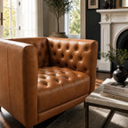 Wellington Leather Club Chair in warm brown leather with deep tufting, placed in a stylish living room.