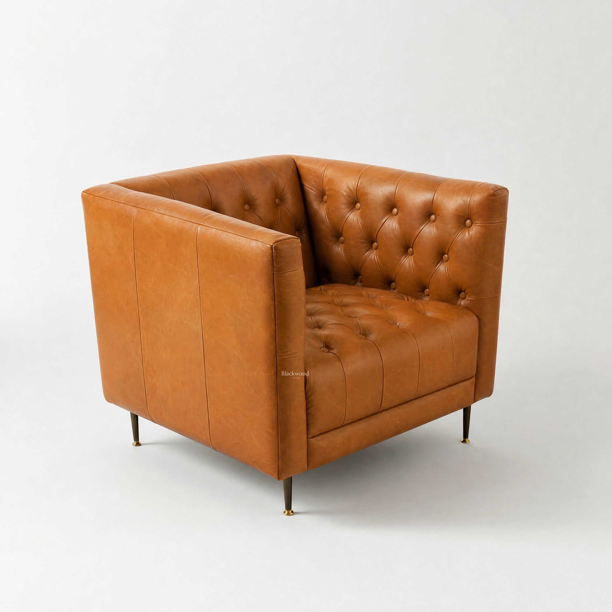 Wellington Leather Club Chair in warm tan leather with deep button tufting and generous proportions.