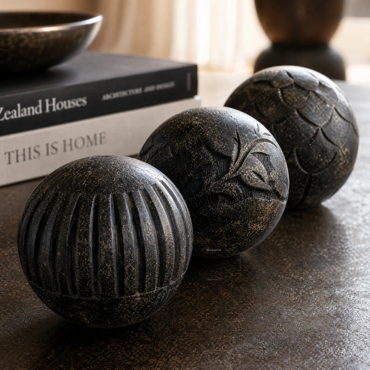Vinewood Decorative Spheres Black, hand-carved mango wood with intricate patterns and textured finish on shelves.