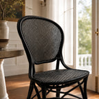 Sika Rossini Rattan Side Chair in black with woven seat and back, shown indoors.