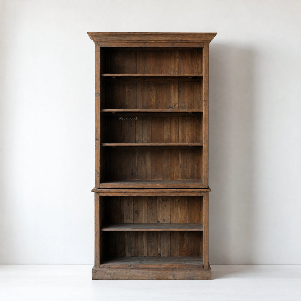 Wycliffe Bookcase in recycled pine with textured finish; tall, warm, substantial shelving unit with detailing.