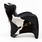The Huntsman Chair in black top-grain leather with cowhide panels and saddle-inspired straps.