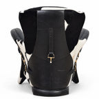 The Huntsman Chair in black South American leather with cowhide detailing and saddle-inspired straps.