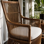 Sika Design DaVinci rattan armchair featuring a sculptural high back, generous arms, and a cream cushion for relaxed elegance.