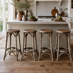 Four Villard bar stools with solid elm wood and handwoven rattan seats in a farmhouse kitchen.