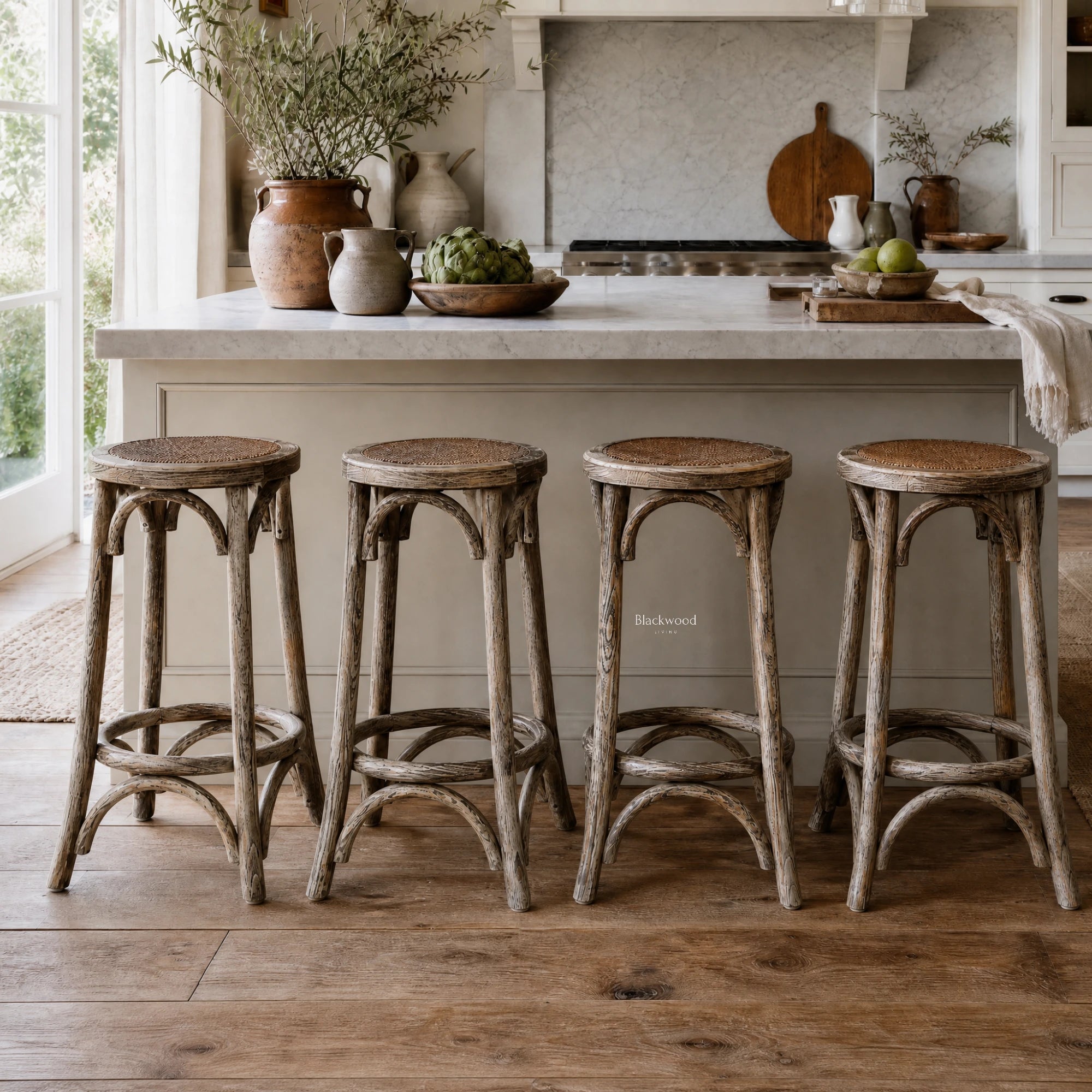Four Villard bar stools with solid elm wood and handwoven rattan seats in a farmhouse kitchen.