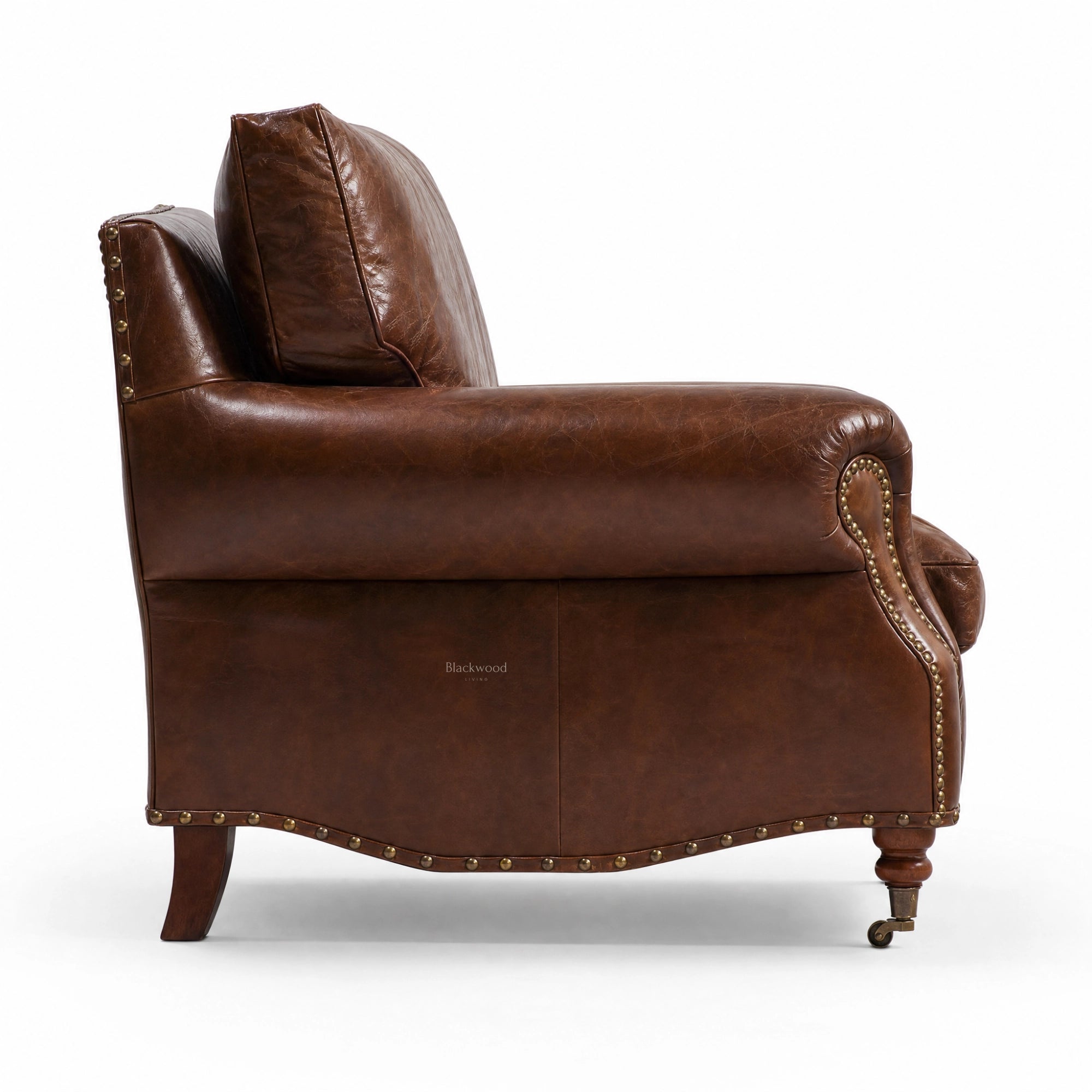 Side view Churchill Leather Armchair in brown South American leather with brass stud trim