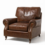 Churchill leather armchair with rolled arms and classic nailhead trim against a white background.