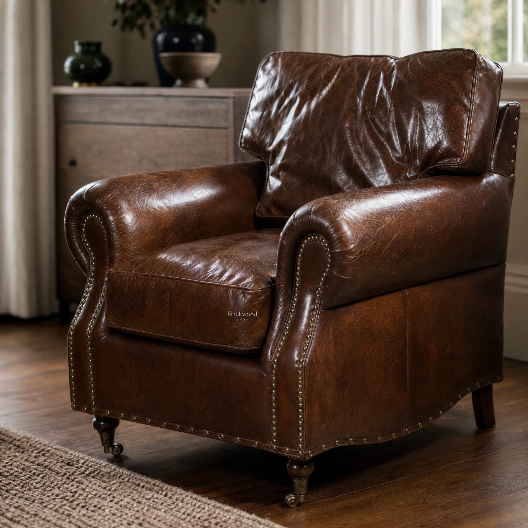 Classic brown leather Churchill armchair with rolled arms and antique brass nailhead trim